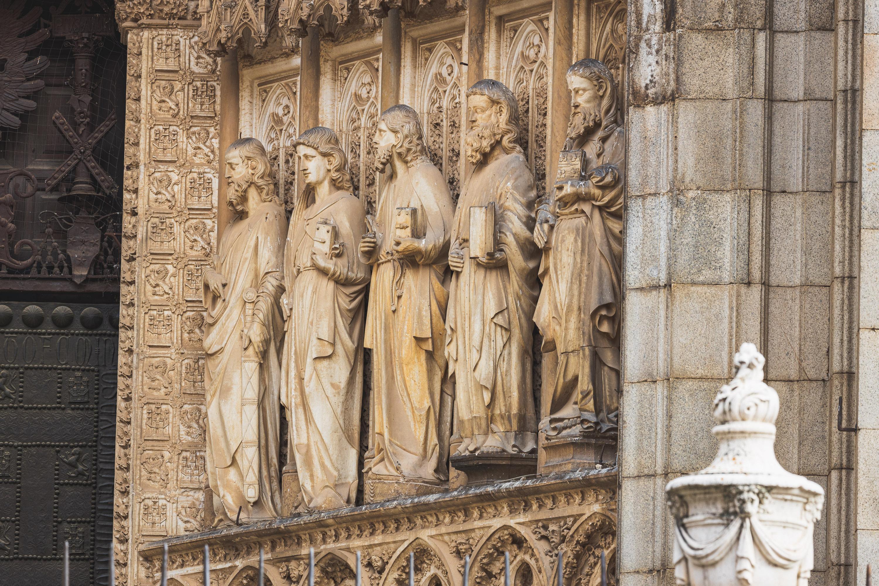 Architectural reliefs and statues outside Tolego Cathedral in Spain, carved into aging rock