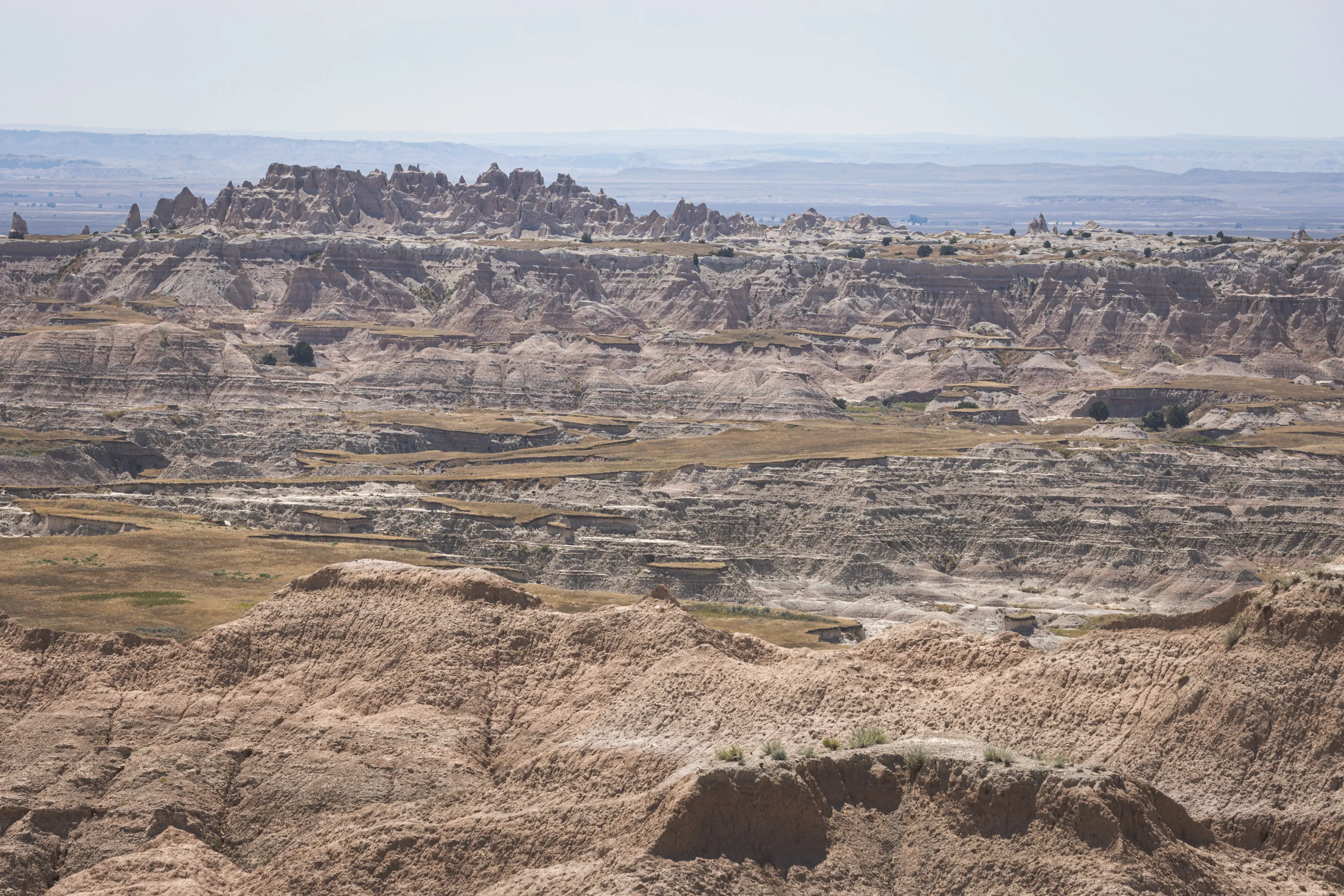 A view into the distance showing rocky terrain occasionally pierced by patches of smooth grassland
