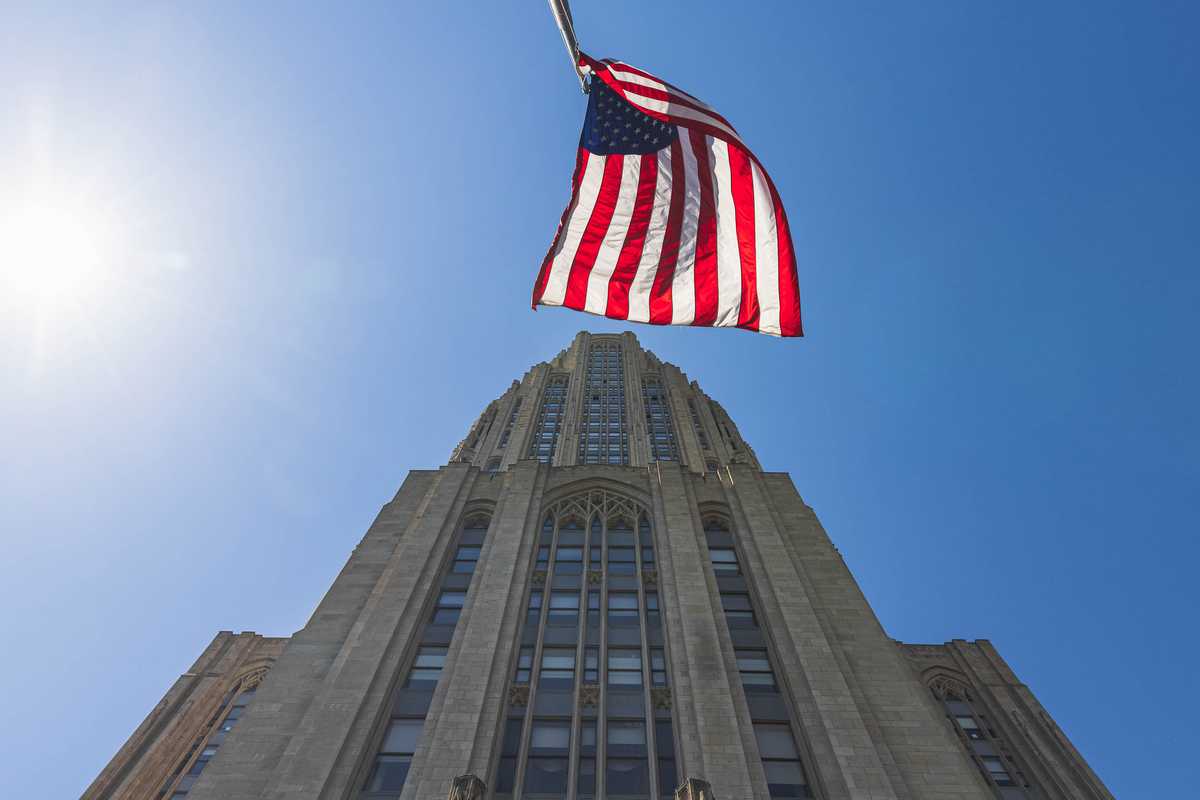 The University of Pittsburgh's Cathedral of Learning with the American Flag out front