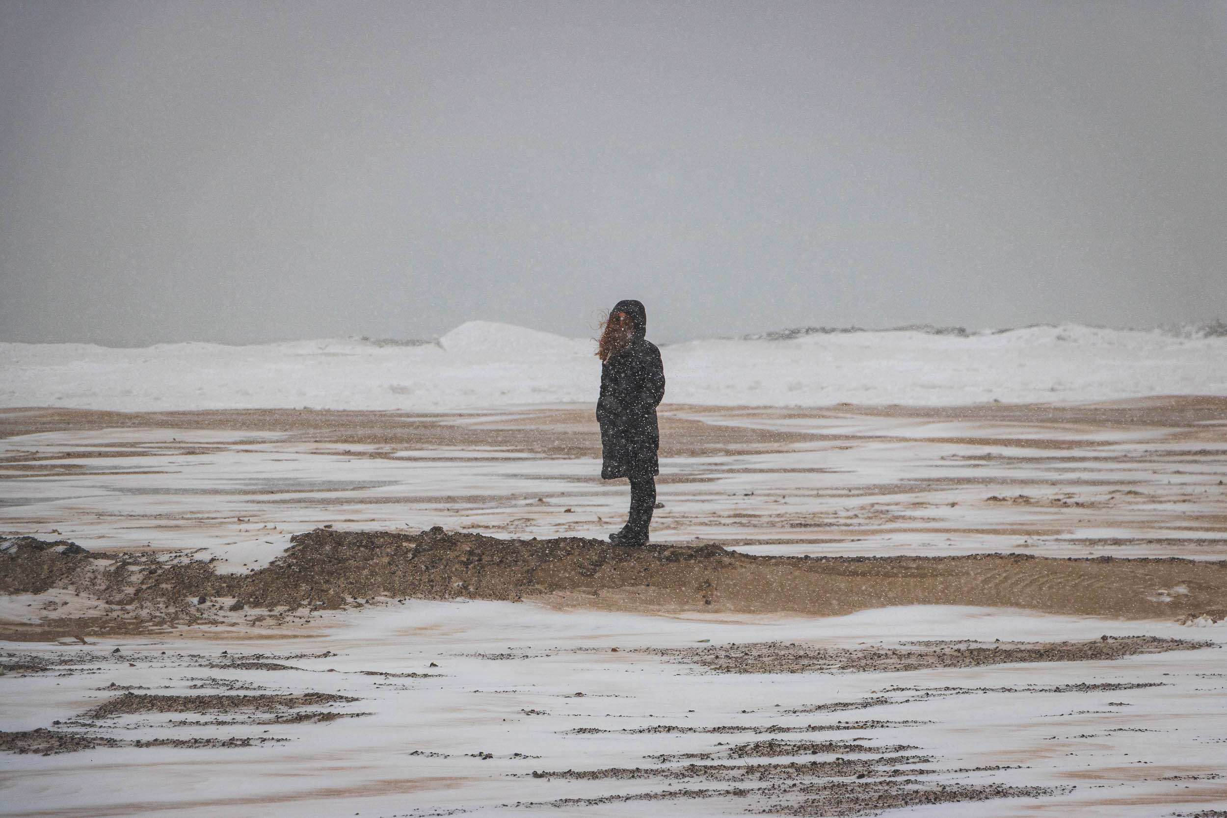 Jenna standing in a blizzard at the shore of Lake Michigan in Chicago