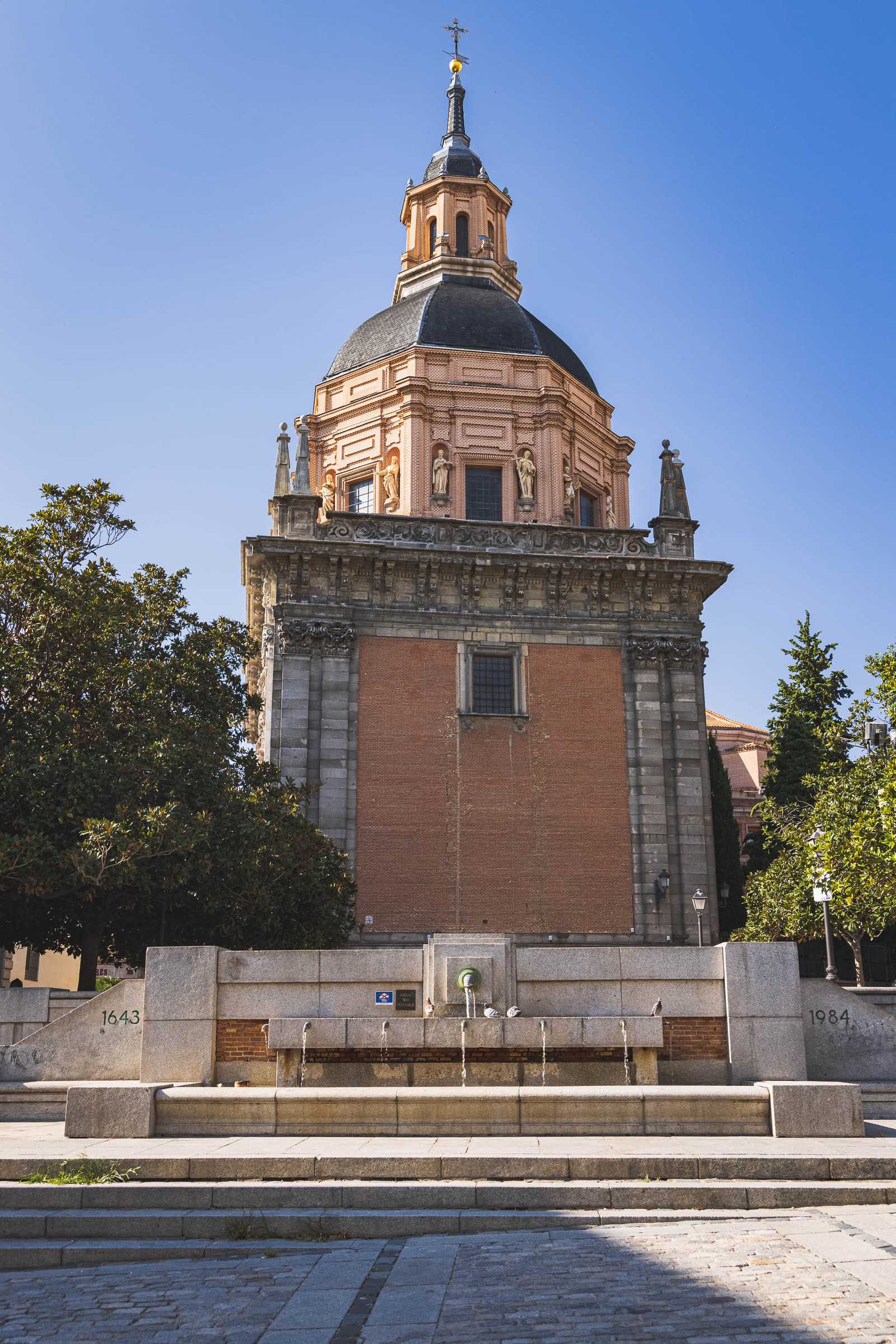 A fountain behind a church