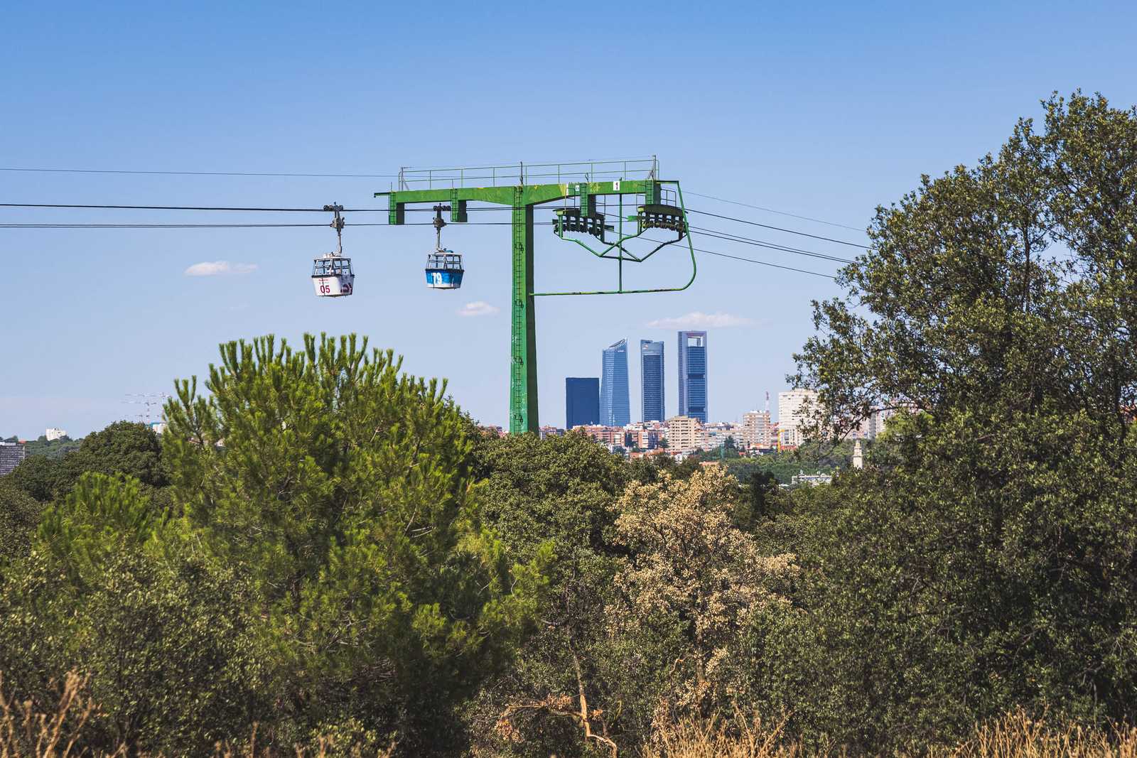 The Cuatro Torres silhouetted under the Teleférico from the park