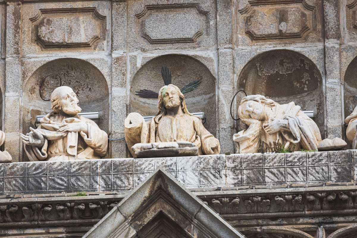 Architectural reliefs and statues outside Tolego Cathedral in Spain, carved into aging rock