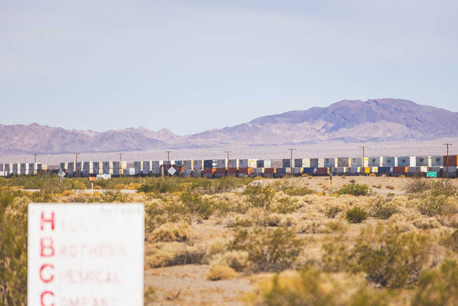 A long train passes in the desert