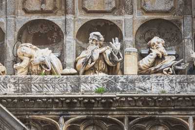 Statues of saints making gestures carved into one of the entryways to the Toledo Cathedral.