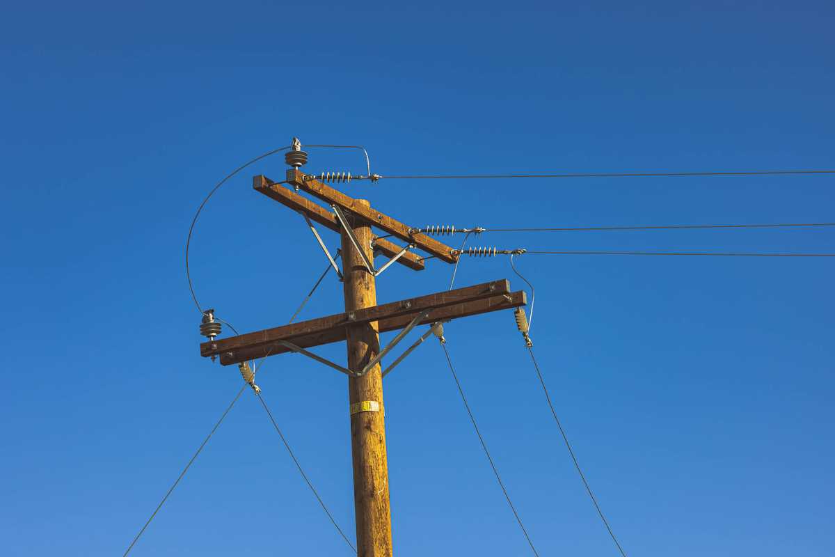 A phone pole against clear blue desert skies