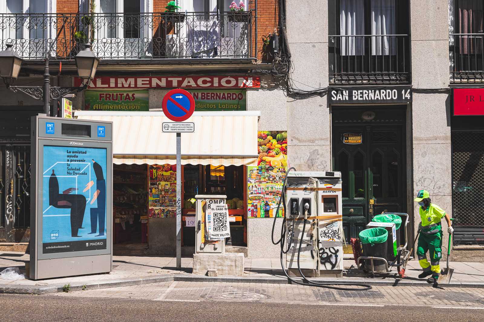 Life happening in Madrid; a sanitation worker outside of a market
